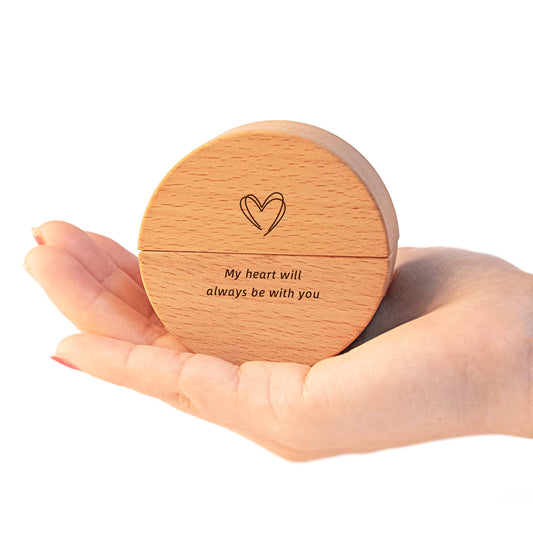 Custom engraved round wooden keepsake urn held in palm – laser etched heart and "My heart will always be with you", natural wood grain