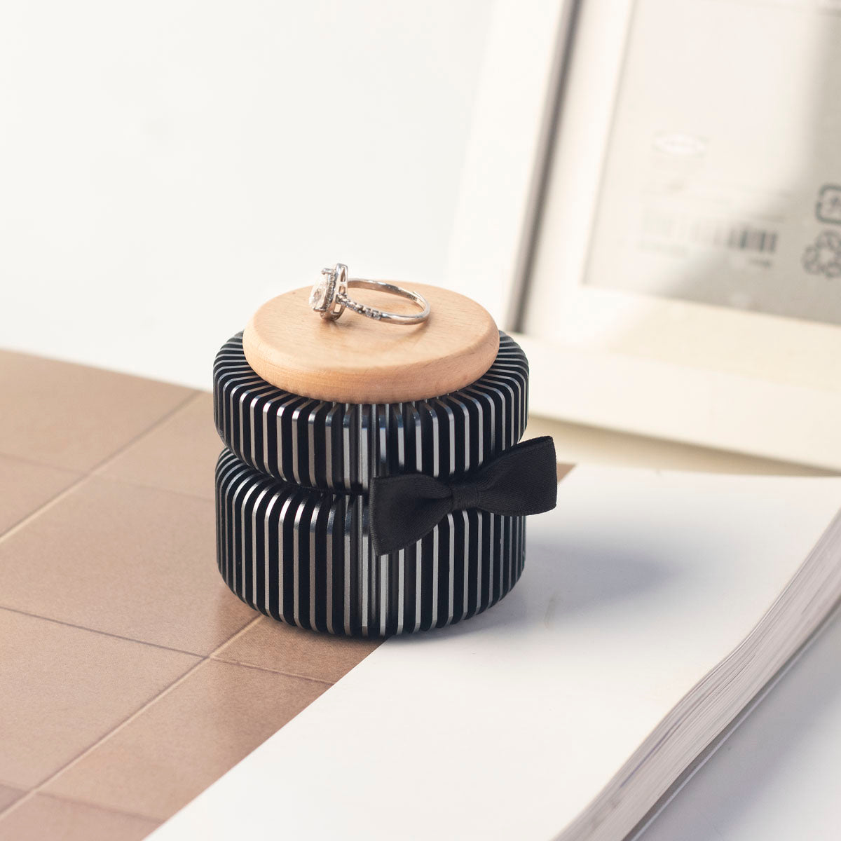 Dark gray keepsake urn with black ribbon bow – anodized aluminum vertical stripes, beech wood lid with ring placement, elegant memorial home decor