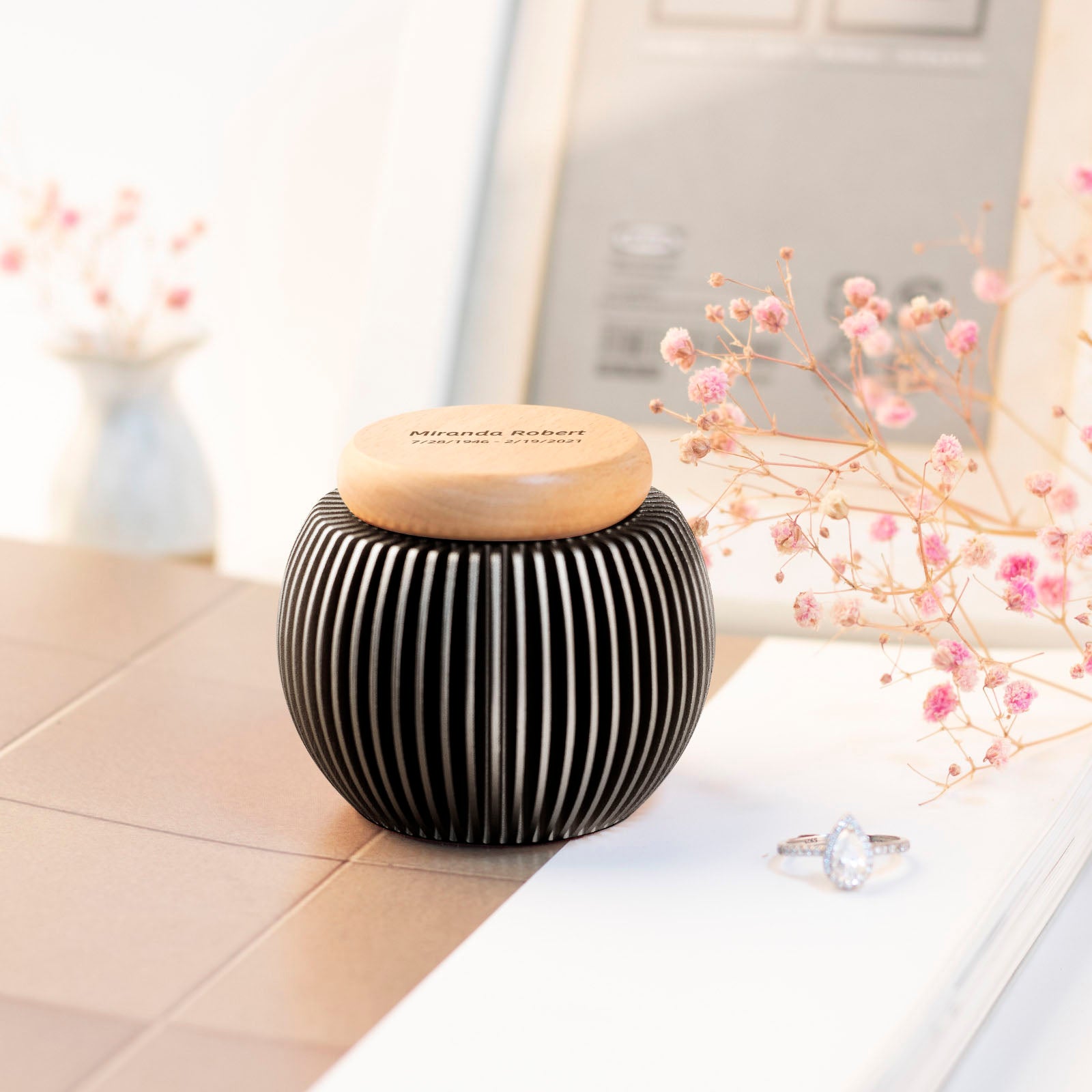 Dark gray egg-shaped keepsake urn with custom engraving on beech wood lid – elegant home display