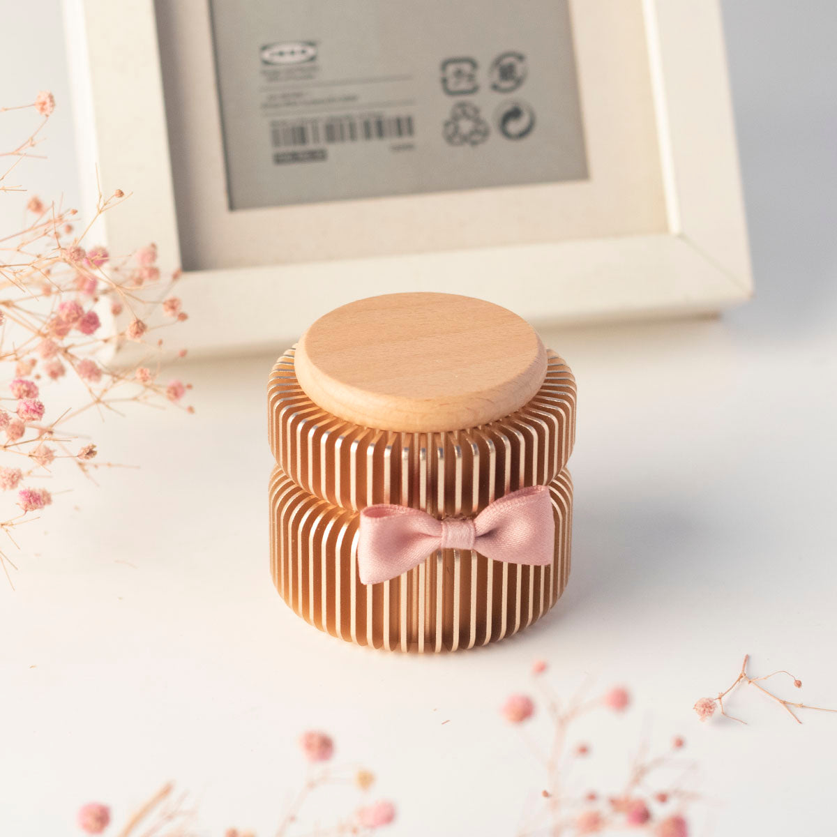 Rose gold keepsake urn in home display setting – on desk with dried flowers and picture frame, warm memorial decor for everyday remembrance