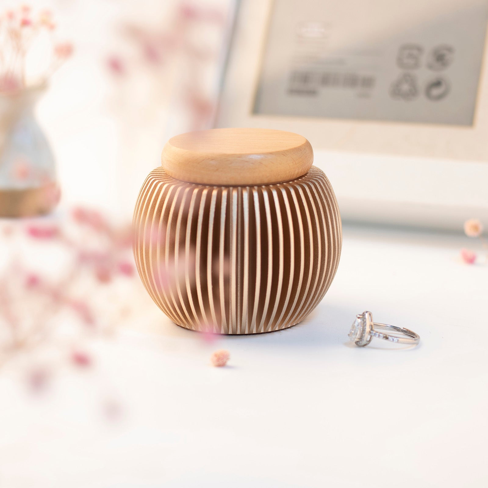 Rose gold egg-shaped keepsake urn with beech wood lid – warm home memorial scene