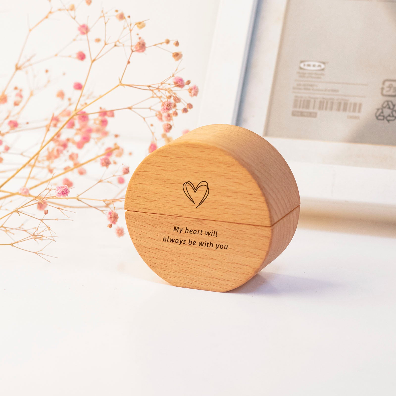 Round wooden keepsake urn with engraved heart and "My heart will always be with you" – home display on desk with dried flowers, memorial decor for loved one